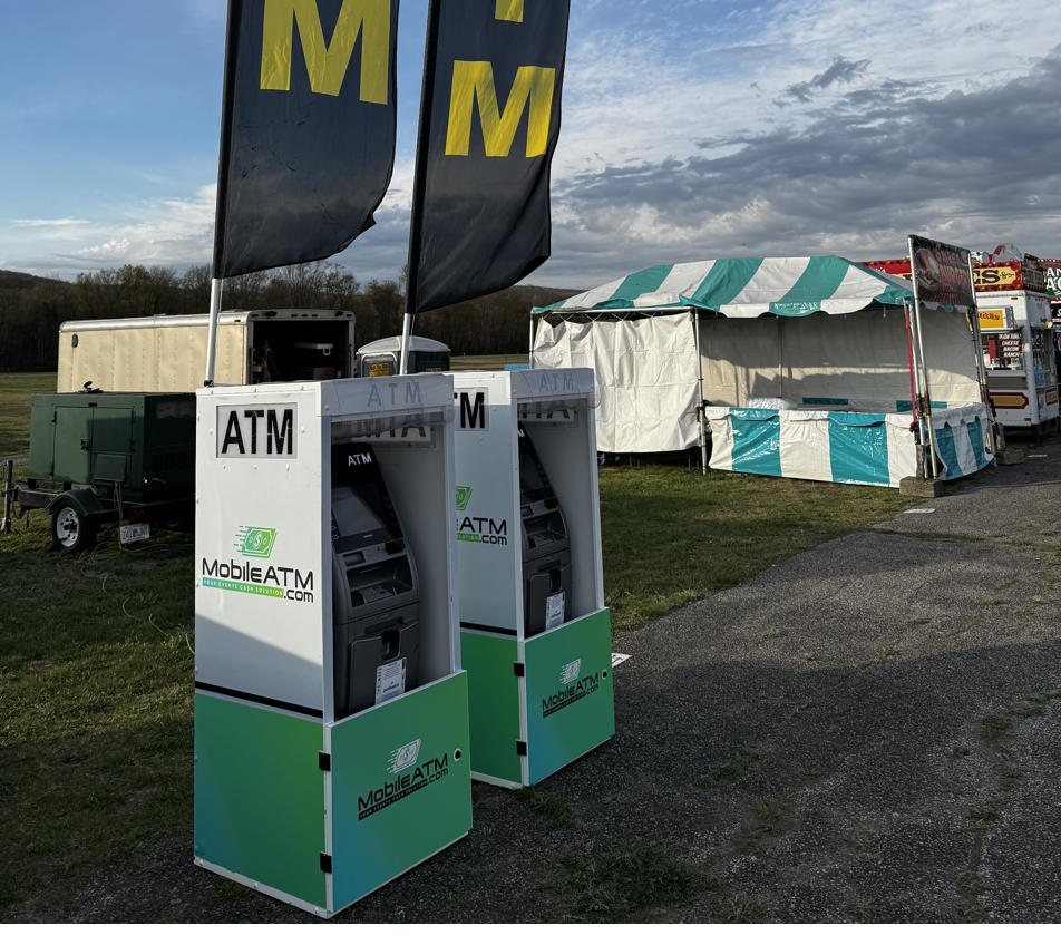Rental ATMs on a county fair midway in New York with food vendors behind