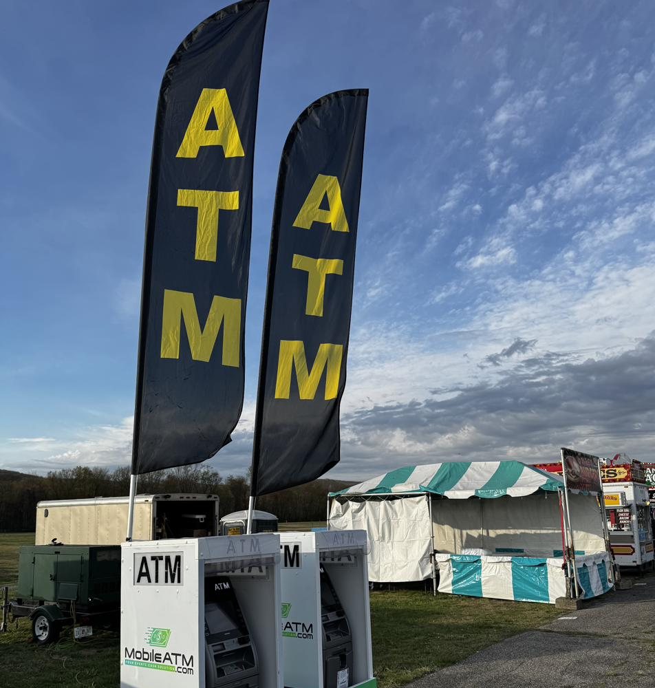 ATM flags above MobileATM.com event ATM machines at a fair in New York's Hudson Valley